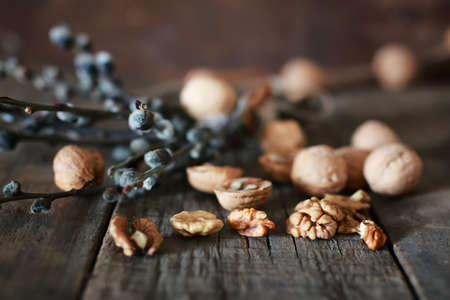 Dried chopped walnuts on a wooden background old shabbyの写真素材