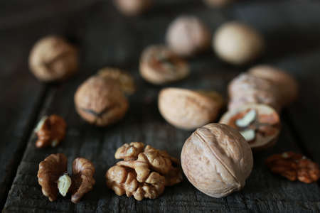 Dried chopped walnuts on a wooden background old shabbyの写真素材