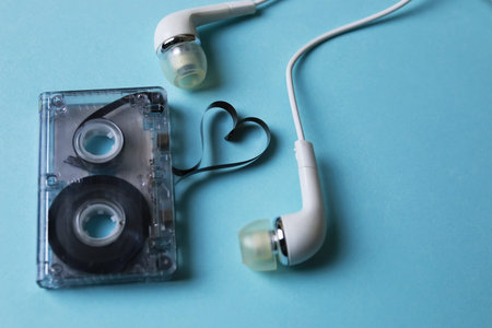 audiocassette retro music and film of her folded in the shape of a heart and headphones