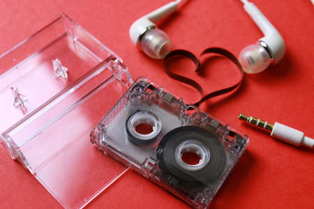 audiocassette retro music and film of her folded in the shape of a heart and headphonesの写真素材