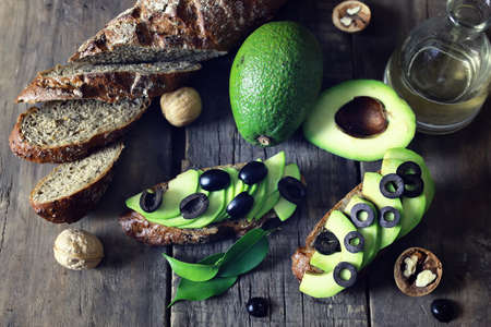 ripe juicy buttery avocado on a wooden table old texturalの写真素材