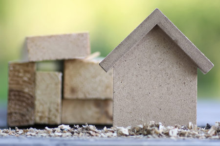 small wooden toy house and building inventory concept construction work