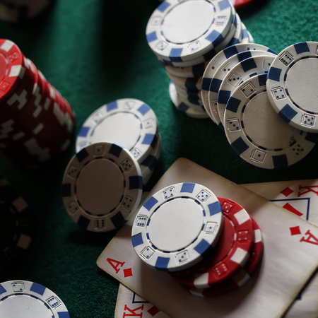 green felt on the poker table chips and cards ready to playの写真素材