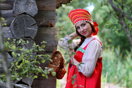 beautiful young girl in traditional red dress Slavic cultureの写真素材