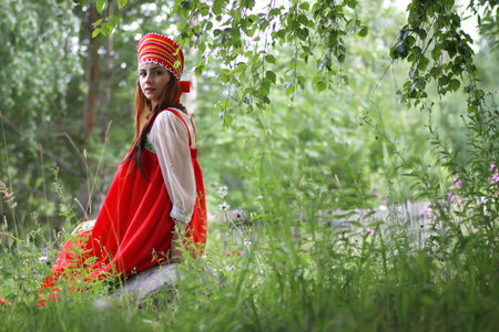 beautiful young girl in traditional red dress Slavic cultureの写真素材