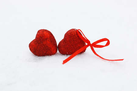 Snowy day shape of hearts red color in winter dayの写真素材