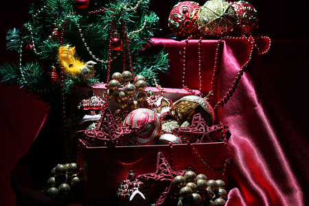 decorated with a satin cloth festive table with glasses of wine and a dressed Christmas treeの写真素材