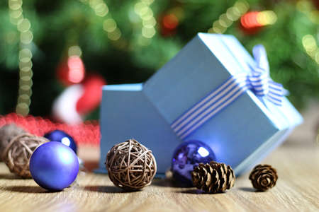 Christmas gift in the blue box with a bow with a bright-colored toysの写真素材