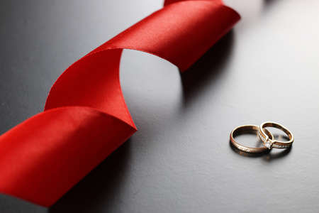 satin ribbon on a black matte background and the shape of the heartの写真素材
