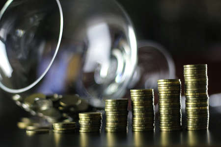 a lot of stacks of coins increasing yellow gradually the concept of progress and growthの写真素材