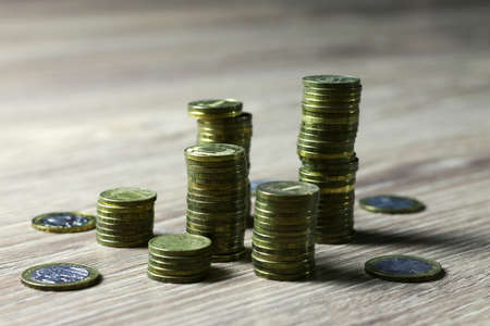 a lot of stacks of coins increasing yellow gradually the concept of progress and growthの写真素材