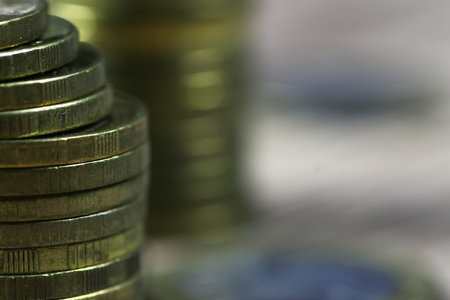 a lot of stacks of coins increasing yellow gradually the concept of progress and growthの写真素材