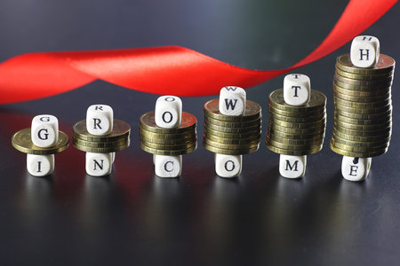 background for business small wooden letters and coins depict climbing up the stairs