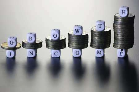 background for business small wooden letters and coins depict climbing up the stairs