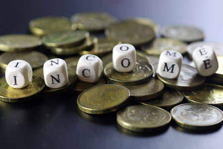 background for business small wooden letters and coins depict climbing up the stairsの写真素材