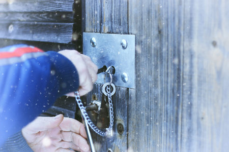 winter landscape on a suburban area with an old wooden house and snow-covered lawnの写真素材
