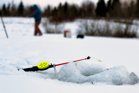 Men's winter fun hike to the pond on the ice-fishingの写真素材