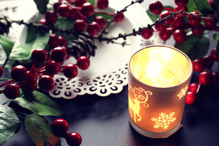 home d?cor on the table candle in a glass lamp and dry larch branchの写真素材