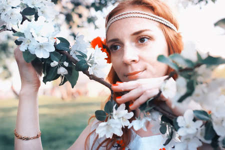 portrait of a happy young girl of European appearance with warm spring sunny dayの写真素材