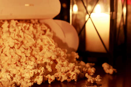 a scattering of popcorn on the wooden floor while watching a movieの写真素材