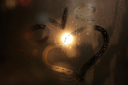 word love on the glass with drops indoor in winter eveningの写真素材