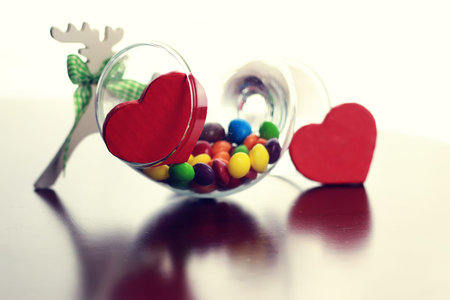 colored jelly beans and candy in a glass transparent glass on a table