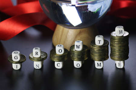 background for business small wooden letters and coins depict climbing up the stairsの写真素材