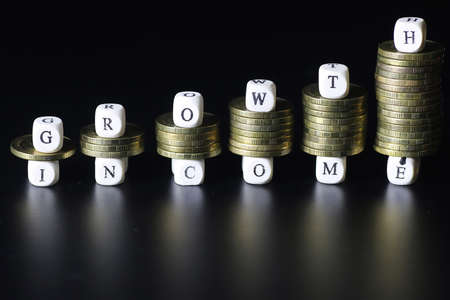 background for business small wooden letters and coins depict climbing up the stairsの写真素材
