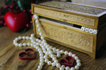 jewelry items on a wooden table in the texture of patterned wooden boxの写真素材