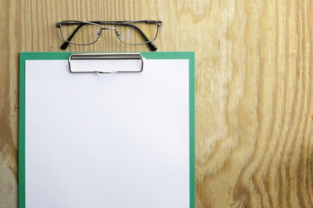 background papers and notebooks on a wooden table bright texturalの写真素材