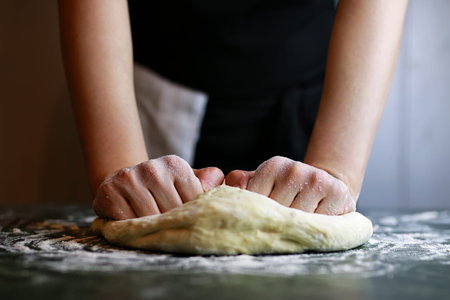 dough for pizza with cherry tomatoes and basil smoked sausage