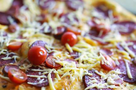 dough for pizza with cherry tomatoes and basil smoked sausageの写真素材