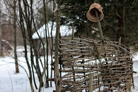 winter landscape on a suburban area with an old wooden house and snow-covered lawnの写真素材