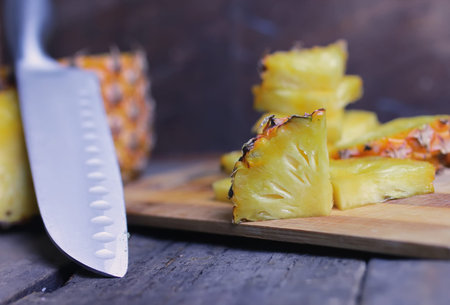 Fresh juicy pineapple on a background of Indian natural texture of wood sheet