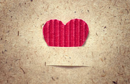 decoration with a symbol of warmth and love of a small paper heartの写真素材