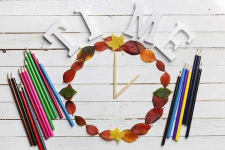 watches from leaves on a white wooden background