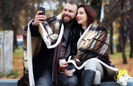 date in a park happy lovers on a bench in autumn