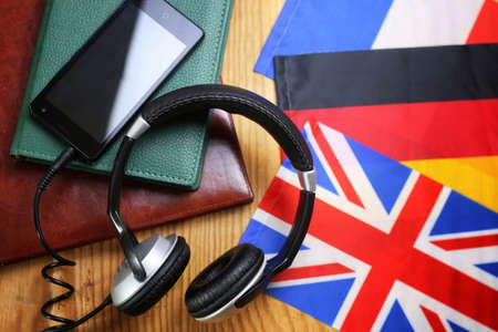 headphones and flag on a wooden background concept course languageの写真素材
