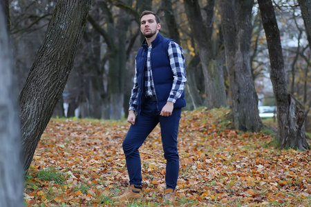 handsome beard man in autumn park posing on cameraの写真素材
