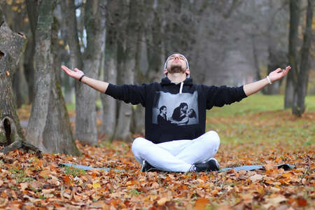 handsome beard man in autumn park posing on cameraの写真素材