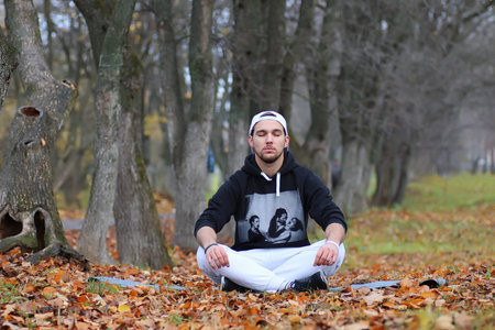 handsome beard man in autumn park posing on cameraの写真素材