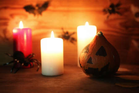 old table decorations for Halloween carved pumpkin head candlesの写真素材