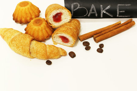 Full-flavored sweet fresh baked muffins and other sweets on a white backgroundの写真素材