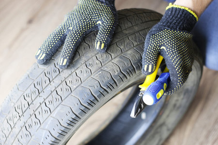 man changing tire wheels winterの写真素材