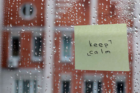 background rain drops on glass and a sticker with the inscription on itの写真素材