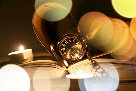 book made up in shape of heart and pocket retro watches candlesの写真素材