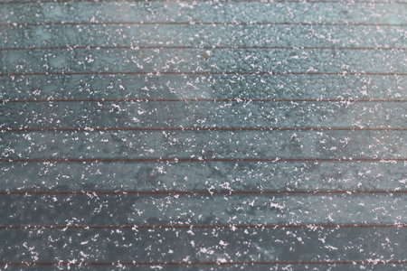 frozen snow frost on the window of the car on a winter morning