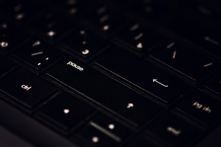 black laptop computer keyboard keys and headphones on itの写真素材