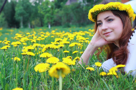 portrait of a cute beautiful girl of European appearance on nature in a summer dayの写真素材