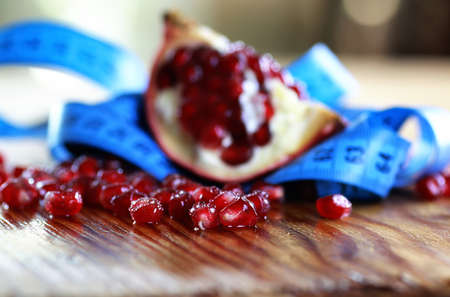 diet mesaure fruit pomegranate on wooden backgroundの写真素材